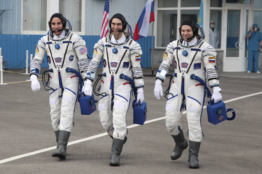 US astronaut Chris Cassidy, left, Russian cosmonauts Anatoly Ivanishin, centre, and Ivan Vagner, members of the main crew of the expedition to the International Space Station (ISS), walk prior the launch of Soyuz MS-16 space ship at the Russian leased Baikonur cosmodrome, Kazakhstan, on Thursday. Picture: Roscosmos Space Agency Press Service