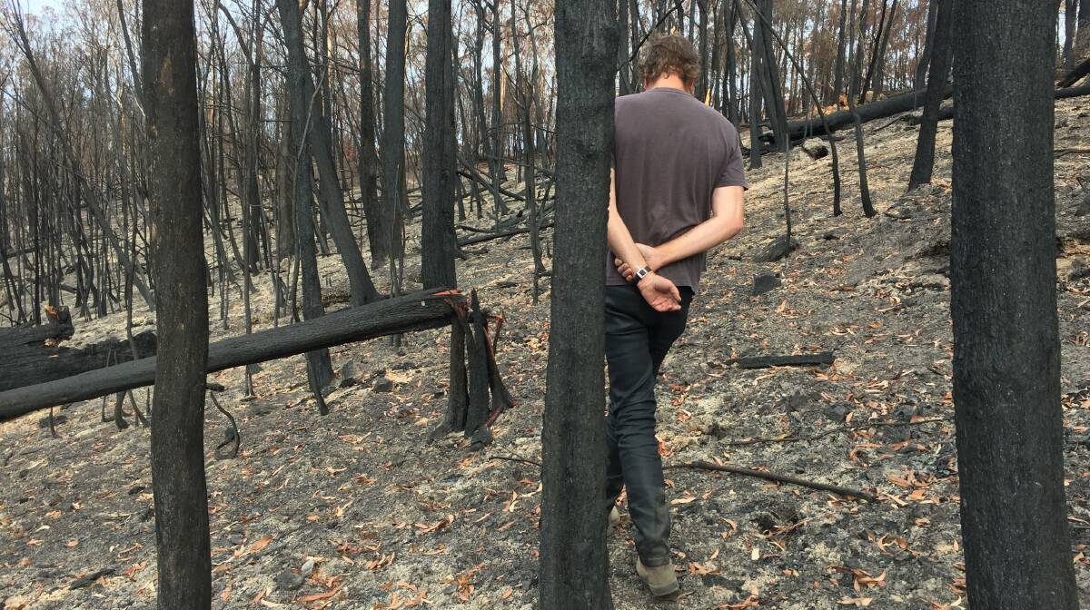 Tony Dean walking through burnt forest after the Tathra District fire in 2018. Picture: Supplied.