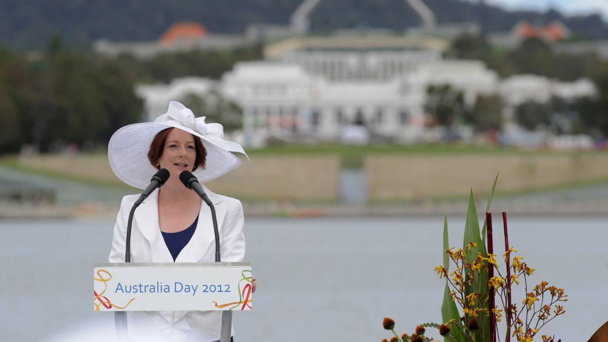 Julia Gillard leading the Australia Day flag raising and citizenship ceremony in Canberra in 2012. Picture: Graham Tidy