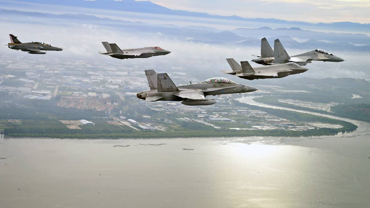 Australia's F-35A Lightning II and Malaysia's Sukhoi Su-30MKM, F/A-18D Hornet and Hawk MK108 aircraft in a five-ship formation over Butterworth Air Base, Malaysia. Picture Defence Department