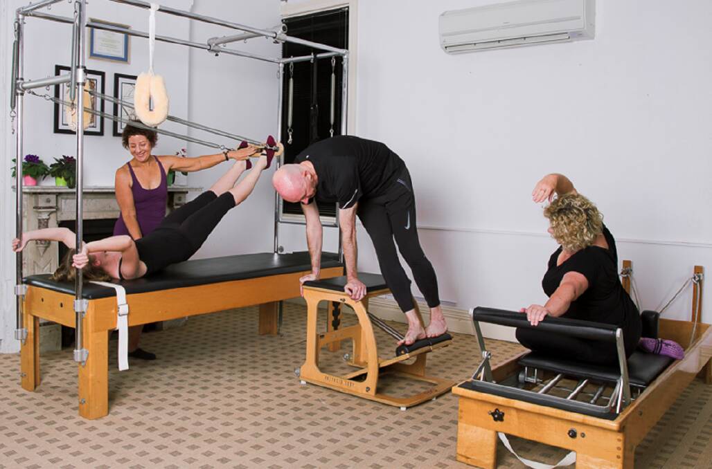 Improving movement: Robyn Rix teaching in her studio using the three major pieces of apparatus Cadillac, Pilates chair and reformer. Pilates offers a host of benefits including flexibility and balance. Picture: Supplied 