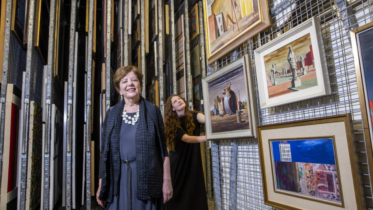 National Gallery of Australia curators Deborah Hart and Rebecca Edwards, with some of Jeffrey Smart's works in storage. Picture: Keegan Carroll