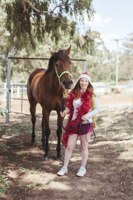 Apprentice jockey for Joe Cleary Ellen Hennessy, with horse Kiss My Swiss at the Queanbeyan stables. Picture: Dion Georgopoulos