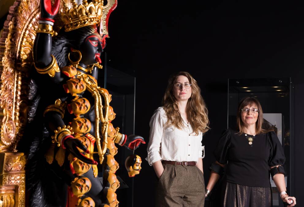 British Museum curator Belinda Crerar and National Museum of Australia curator Cheryl Crilly with an icon of the goddess Kali featured in the exhibition Feared and Revered. Picture by Sitthixay Ditthavong