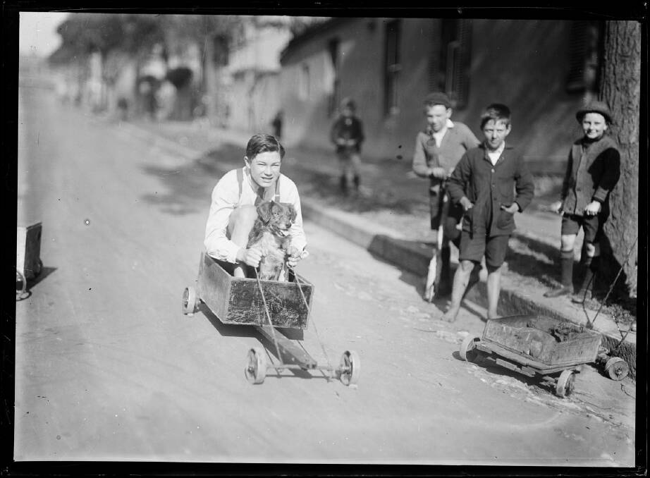 Boy and dog in a billycart race on a suburban street in Sydney in the 1920s. Picture National Library of Australia