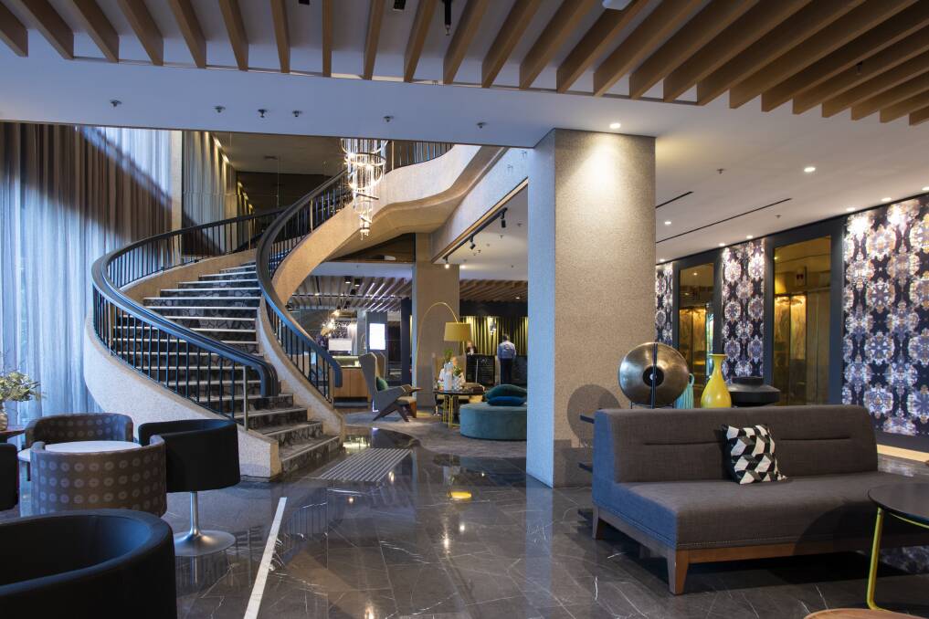 The sweeping staircase in the QT Hotel lobby. Pictures: Supplied