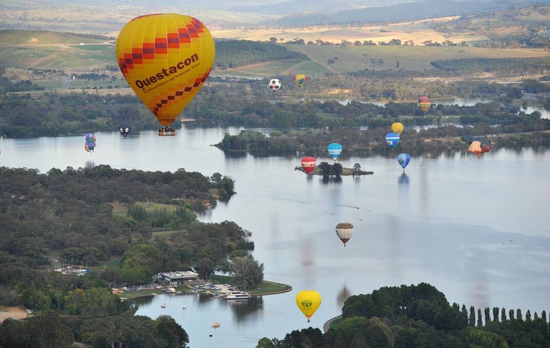Balloons drift over Lake Burley Griffin. Picture: Graham Tidy.