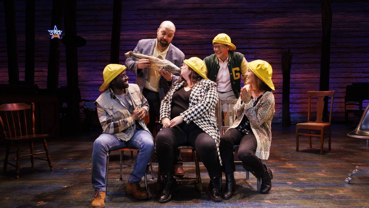 Journalist Amy Martin, centre, kisses the cod with Come From Away cast members Kyle Brown, David Silvestri, Phillip Lowe and Natalie O'Donnell. Picture by Keegan Carroll