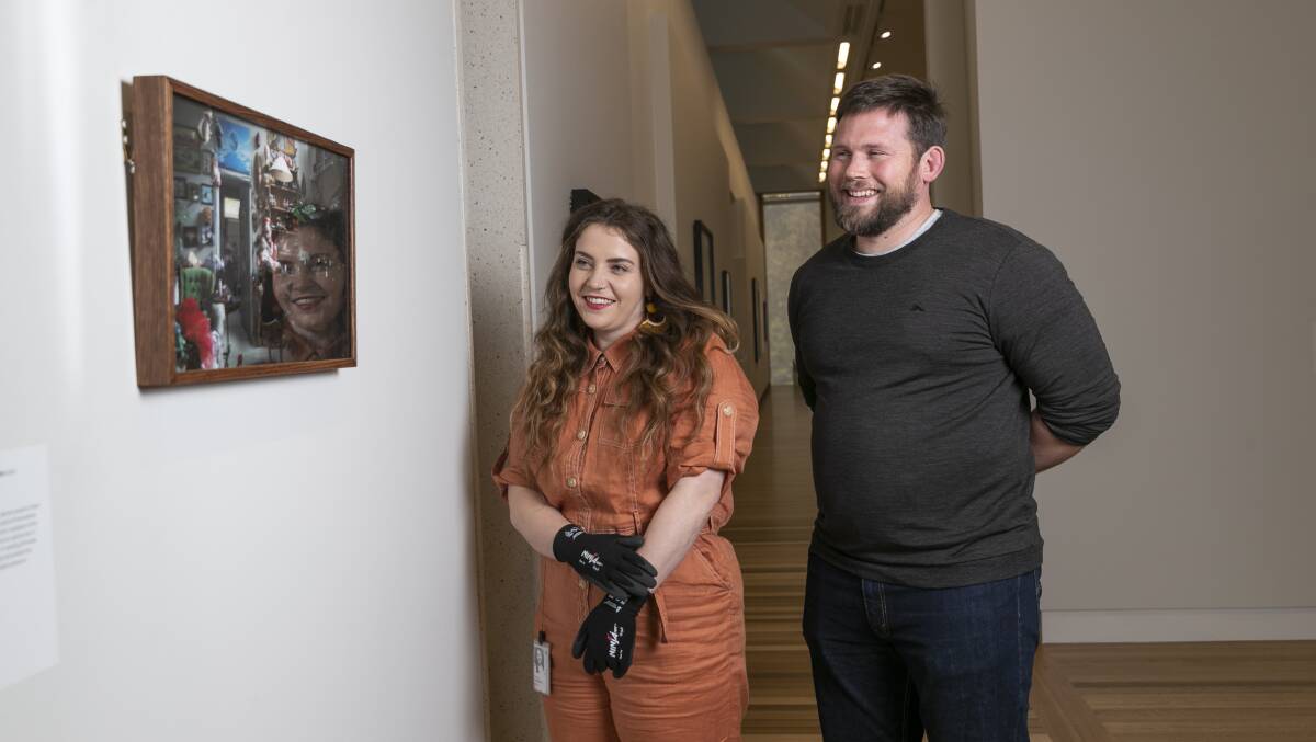 Art handlers Jessica Kemister and James Ley of the National Portrait Gallery with Art Handlers' Award winner "I'm Just a suburban fashionista" by Kristina Krakov. Picture: Keegan Carroll