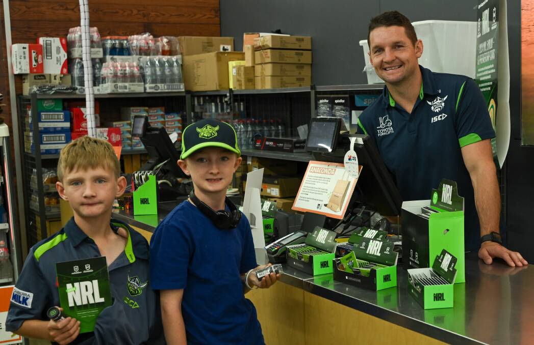 Former Raiders captain Jarrod Croker with fans Damon and Leslie Taylor with their new NRL coin sets. Picture supplied