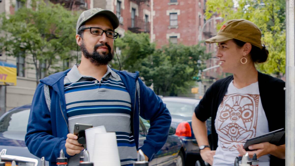 Lin-Manuel Miranda (in costume as Piragua Guy) and producer Quiara Alegra Hudes on the set. Picture: Warner Bros.