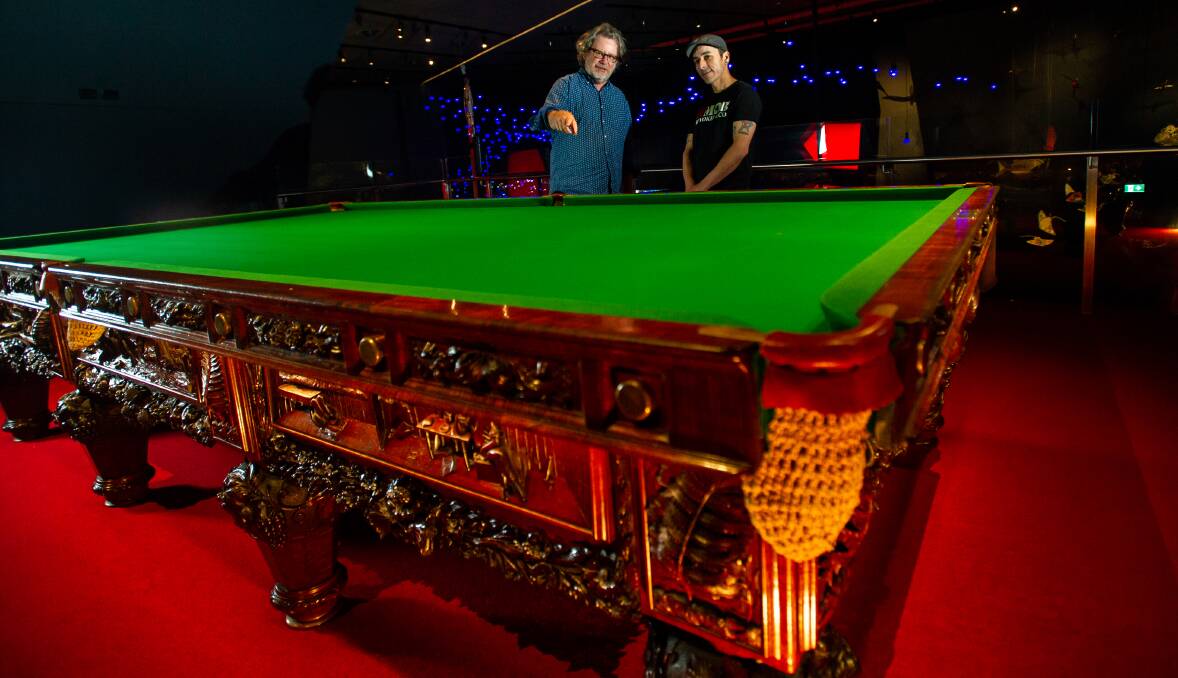 National Museum of Australia's Ian Coates and Nathan Pharaoh with the 1885 billiards table. Picture by Karleen Minney