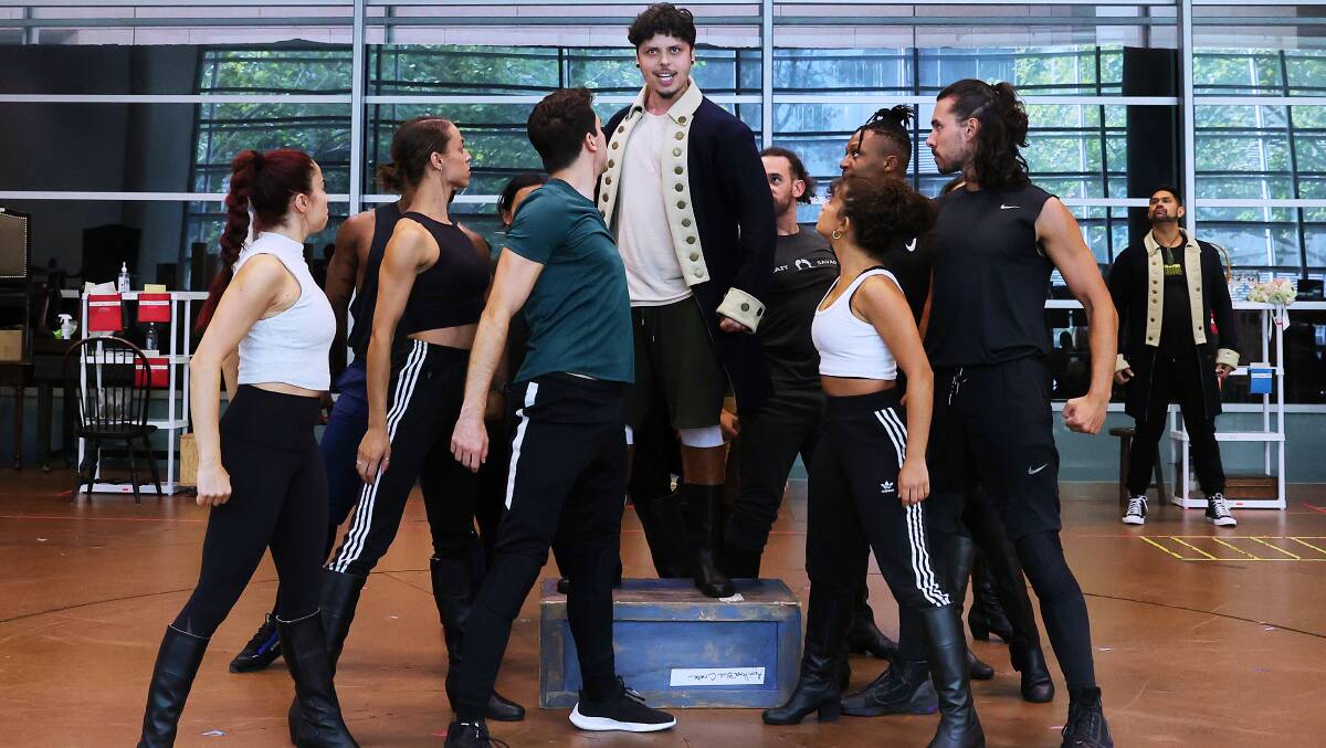 Jason Arrow (centre) as Alexander Hamilton and the essemble during rehearsals for the Australian production of Hamilton. Picture: Lisa Maree Williams