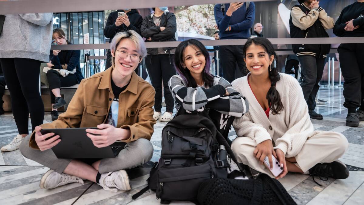 ANU students Wilson Yuen, Anael Lukean and Ishita Sherna were the first in line for UNIQLO's opening at the Canberra Centre. Picture by Karleen Minney