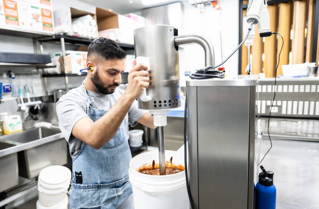 Anuj Sapkota using the emulsifier to ensure the dark chocolate, sugar and water combine correctly. Picture by Karleen Minney