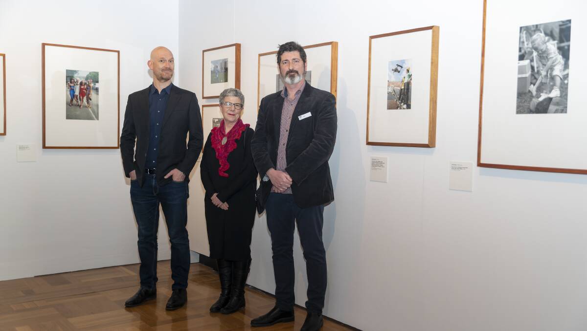 Photographer Dave Tacon, National Library of Australia director-general Marie-Louise Ayres and curator Matthew Jones inside the exhibition, Viewfinder. Picture by Keegan Carroll
