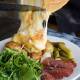 Its a French winter tradition to melt Raclette cheese and drop it on potatoes, ham, salami and pickles. Picture: supplied