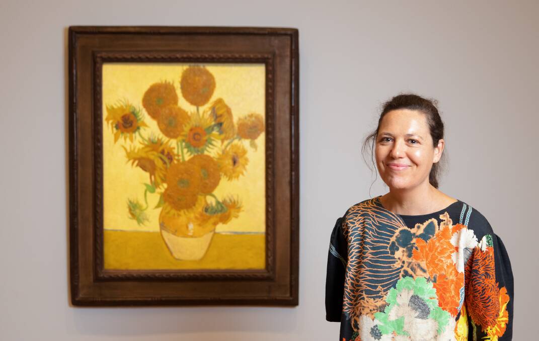 Coordinating curator Sally Foster, from the National Gallery of Australia with Van Gogh's Sunflowers 1888. Picture: Sitthixay Ditthavong