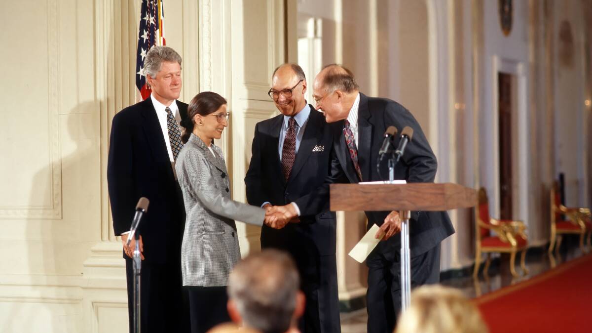 Ruth Bader Ginsburg is sworn in as associate justice of the supreme court of the United States in 1993. President Clinton stands behind her with her husband Martin Ginsburg. Picture: Shutterstock