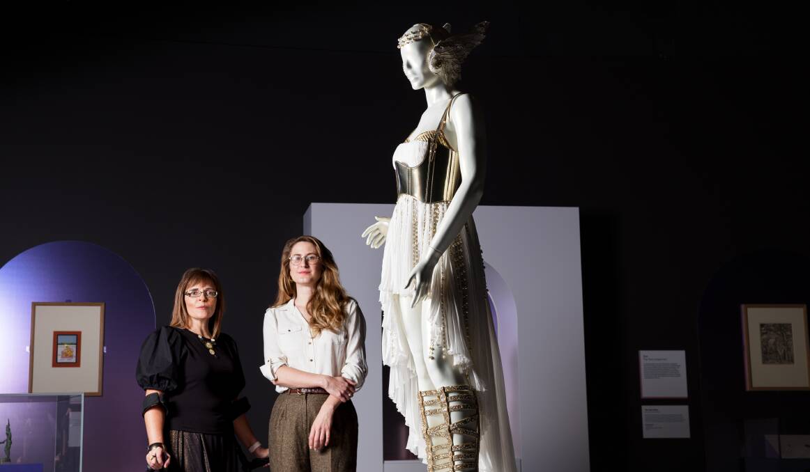 British Museum curator Belinda Crerar and National Museum of Australia curator Cheryl Crilly with the Kylie Minogue costume featured in the exhibition Feared and Revered. Picture by Sitthixay Ditthavong