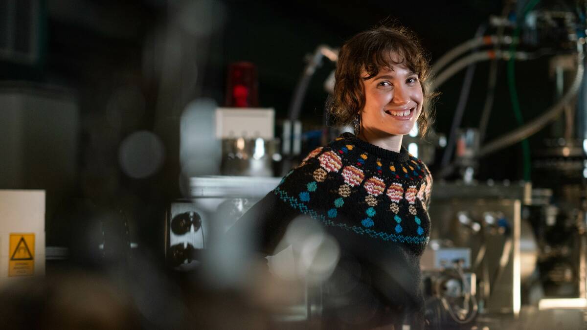 Rachel Kirby in her solar system jumper that she knitted. Picture: Tracey Nearmy/ANU