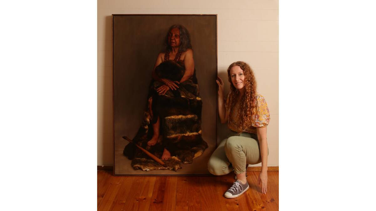 Artist Narelle Zeller with her portrait of Ngambri elder Aunty Matilda House. Picture: Supplied