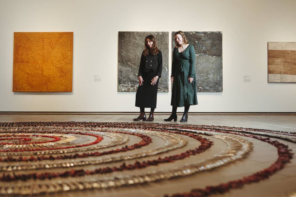 Curator Elspeth Pitt and assistant curator Yvette Dal Pozzo, with Simryn Gill's work Forking tongues in Know My Name at the National Gallery of Australia. Picture: Dion Georgopoulos 