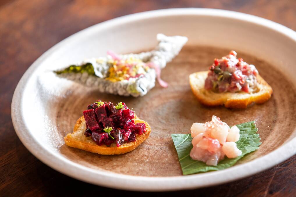 Snack plate: Gim bugak, tofu, cured yolk; beetroot, horseradish, cherry; crudo, ginger, yuzu, finger lime; and agnello tonnoto, pink pepper. Picture: Sitthixay Ditthavong
