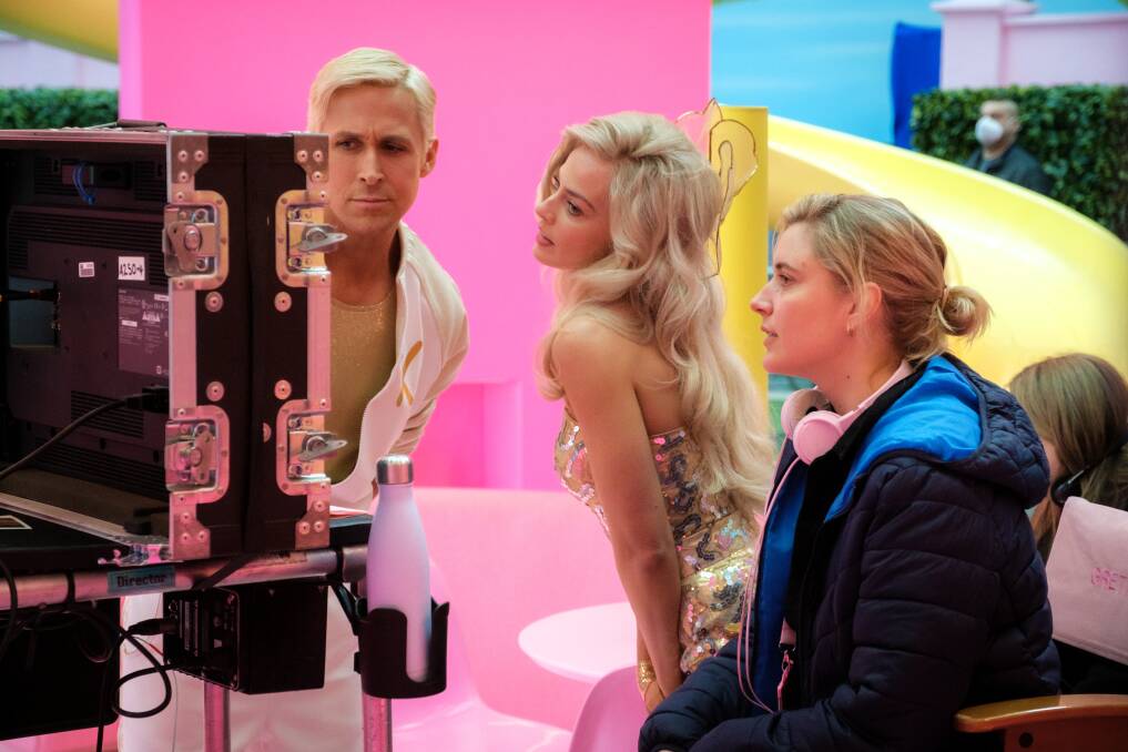 Ryan Gosling, Margot Robbie and director Greta Gerwig on the set of Barbie. Picture Warner Bros