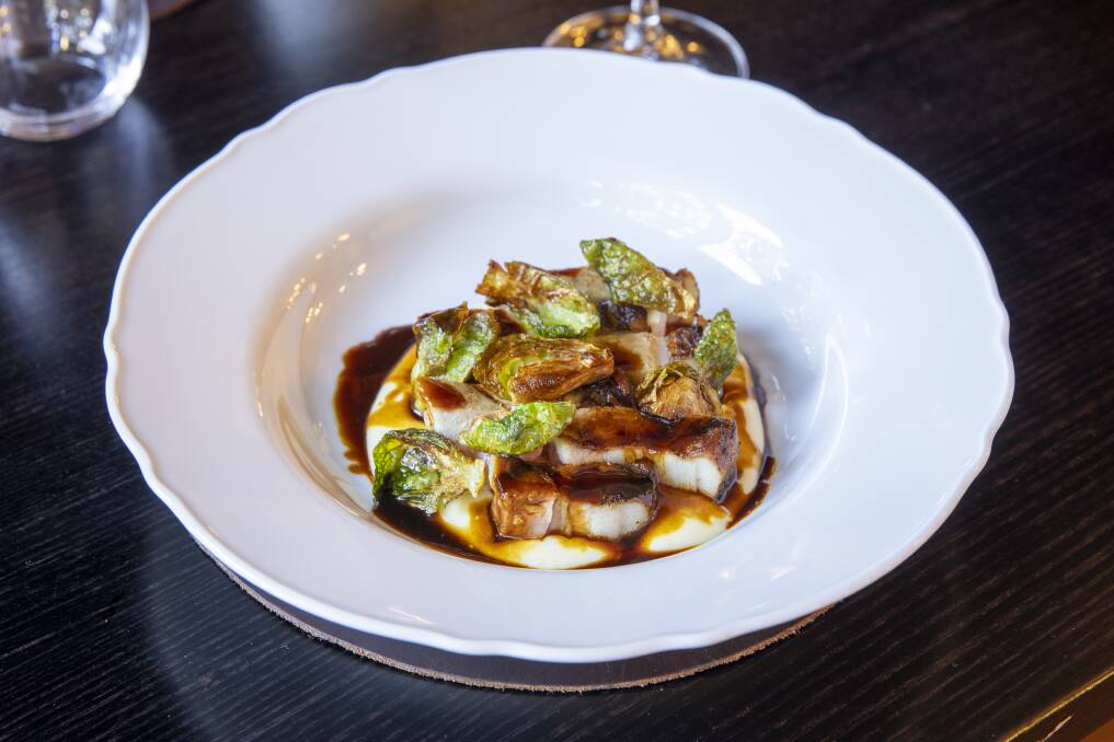 Byron Bay pork chop, fried Brussels sprouts, local smoked bacon, chipotle spiked maple, roquefort butter. Picture: Keegan Carroll
