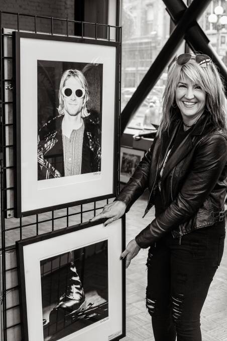 Karen Mason Blair with two of her photographs, including the photo of Kurt Cobain which is on the cover of The Flannel Years. Picture: Supplied
