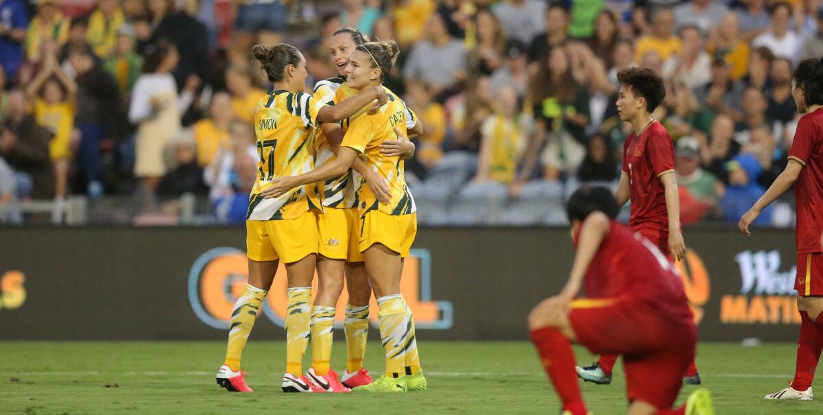 Emily van Egmond is swamped by Matildas teammates after scoring against Vietnam in Newcastle. Picture: Max Mason-Hubers