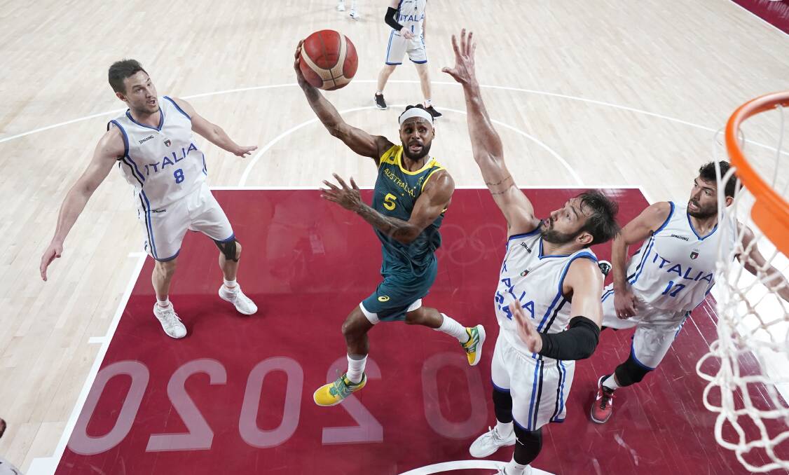 Patty Mills has established himself as the go-to scorer when playing for Australia, but he is happy to take on a different role when he plays for in the NBA. Pictures: AAP and Getty Images