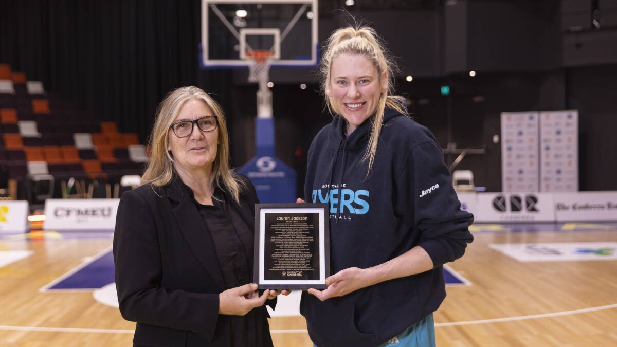 Carrie Graf presented Lauren Jackson with a University of Canberra walk of fame plaque on Saturday. Picture by Keegan Carroll