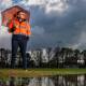 Luke Halpin assesses the water on fields at Lyneham on Friday. Picture: Sitthixay Ditthavong