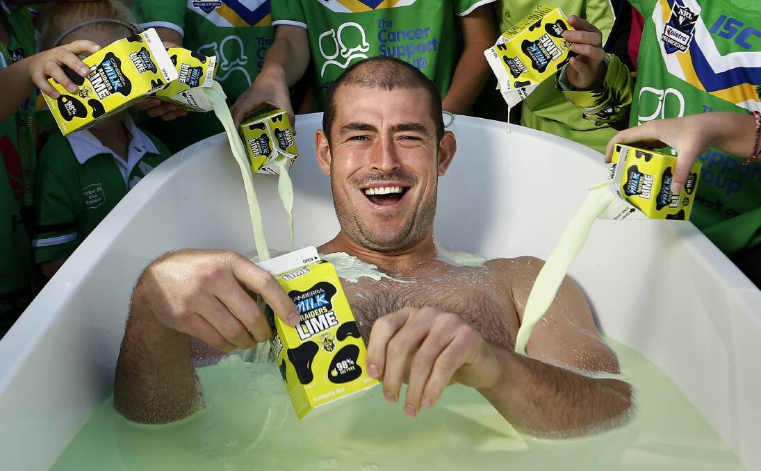 Former Raiders captain Terry Campese in a bath of lime green milk. Picture: Jeffrey Chan