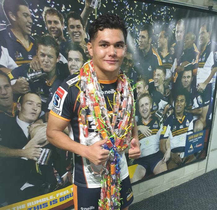 Noah Lolesio celebrated with a traditional Samoan chocolate necklace and, below, Tom Wright staked his claim to be a wing regular this season. Pictures: Getty, Canberra Times