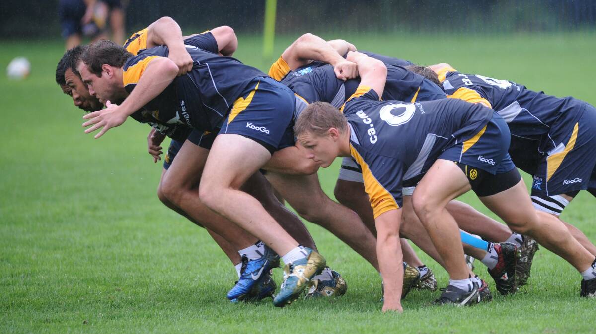 Ben Alexander, left, and Michael Hooper centre at Brumbies training. Picture: Lannon Harley