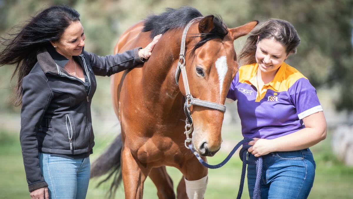 Wallaroo property owner Lia Notaras, left, and stablehand Kia Gorrel are happy to have Game Cove home safe and sporting only a few bandages after bolting from the Queanbeyan racecourse. Picture by Karleen Minney