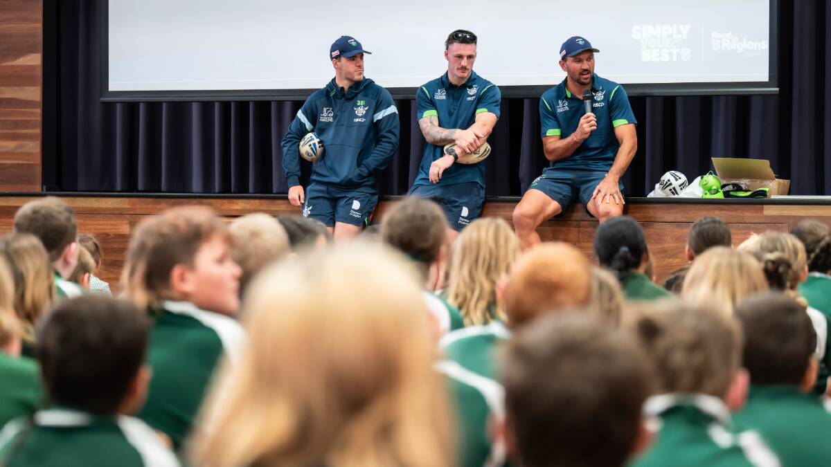 Jordan Rapana, right, and James Schiller, middle, speak to students at Charles Conder school on Monday as part of the Raiders' school blitz across the capital. Picture by Karleen Minney