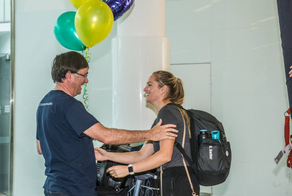 Keith Roberts greeted daughter Kelsey-Lee Barber at Canberra Airport after she won the javelin world title. Picture: Karleen Minney