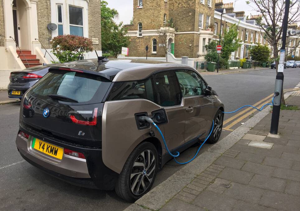 An electric car (EV) charging at an power pole in a London street. Picture by Shutterstock.