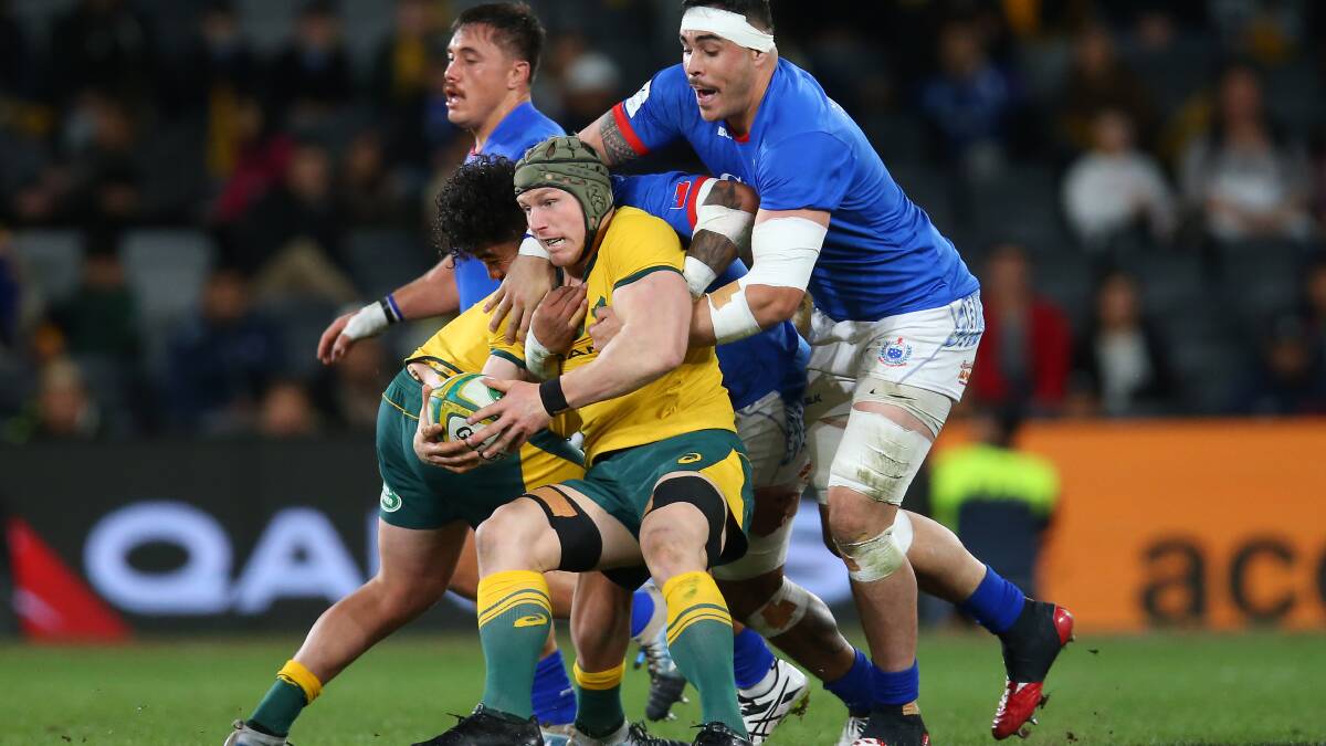 David Pocock is wrapped up by the Samoa defence at Bankwest Stadium. Picture: Getty Images