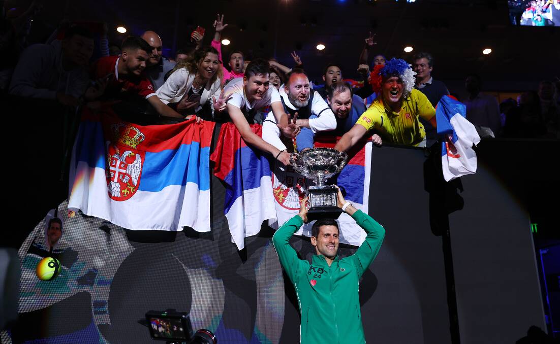 Novak Djokovic shows off the trophy to fans after winning the 2020 Australian Open final. Picture: Getty Images