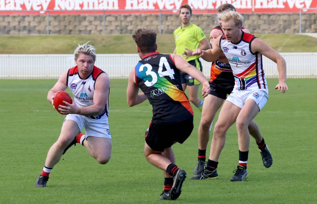Ainslie's Thomas Powell attempts to run past Eastlake's Liam Thompson. Picture: James Croucher