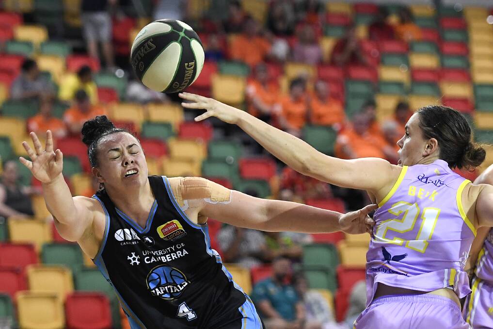 Tahlia Tupaea of the Capitals competes for the ball against Stella Beck of the Boomers during the WNBL semi-final on Wednesday night. Picture: Getty Images