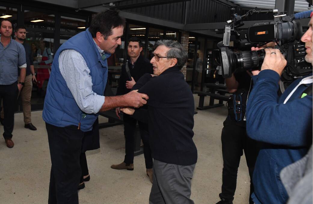 
A man blocks former Australian High Commissioner to Solomon Islands Trevor Sofield from speaking to Prime Minister Scott Morrison at the Ashgrove Cheese dairy door. Picture: AAP