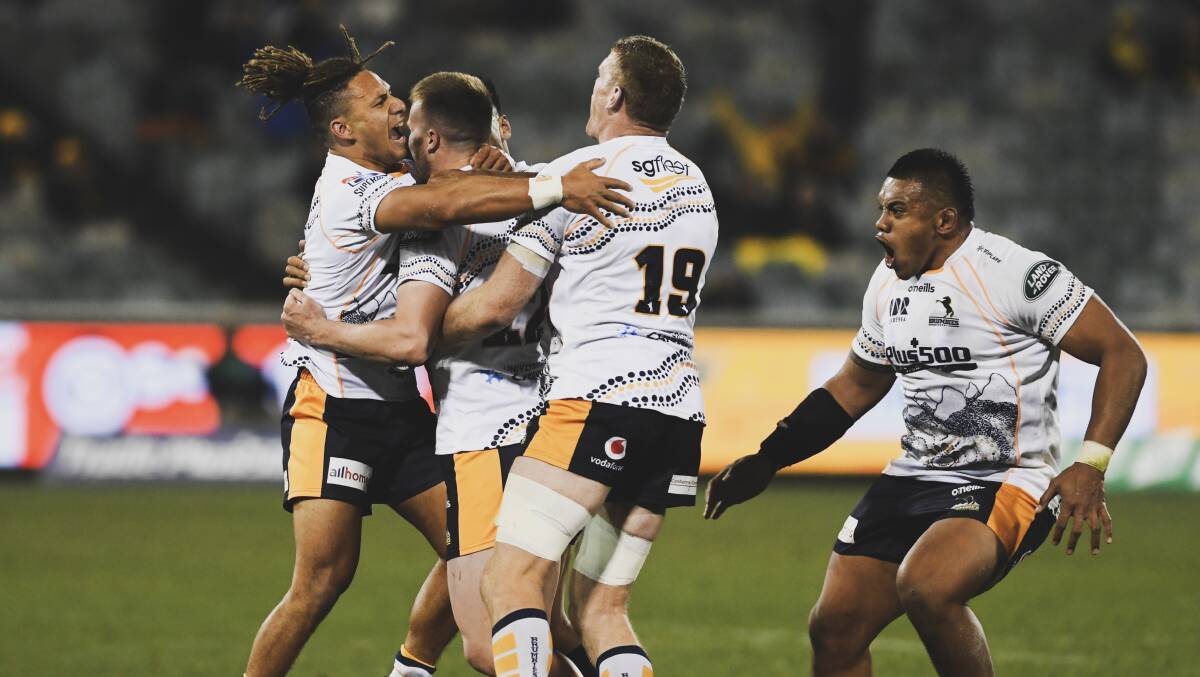 Brumbies players celebrate their win. Picture: Dion Georgopoulos