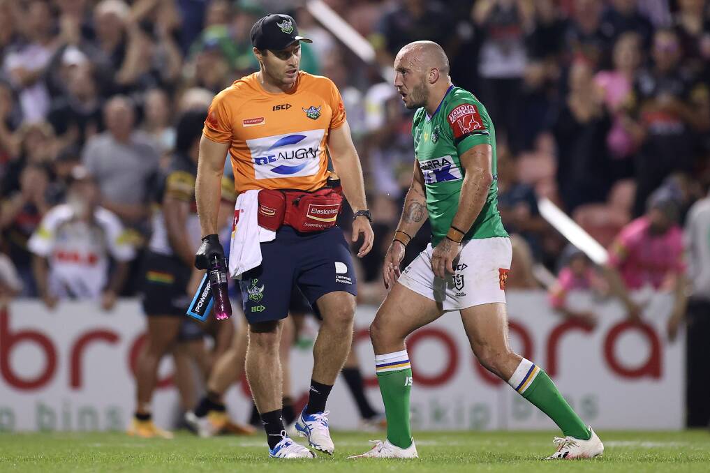 Raiders co-captain Josh Hodgson is attended to by a team trainer against the Panthers on Friday night. Picture: Getty Images