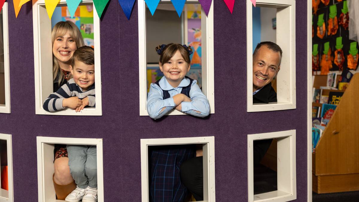 A new early learning centre will open at St Francis of Assisi Primary School Calwell next year. Kylee and Sam Hicks with their daughter Lily, 6, and son Oscar, 3. Oscar will to go the ELC when it opens. Picture by Gary Ramage